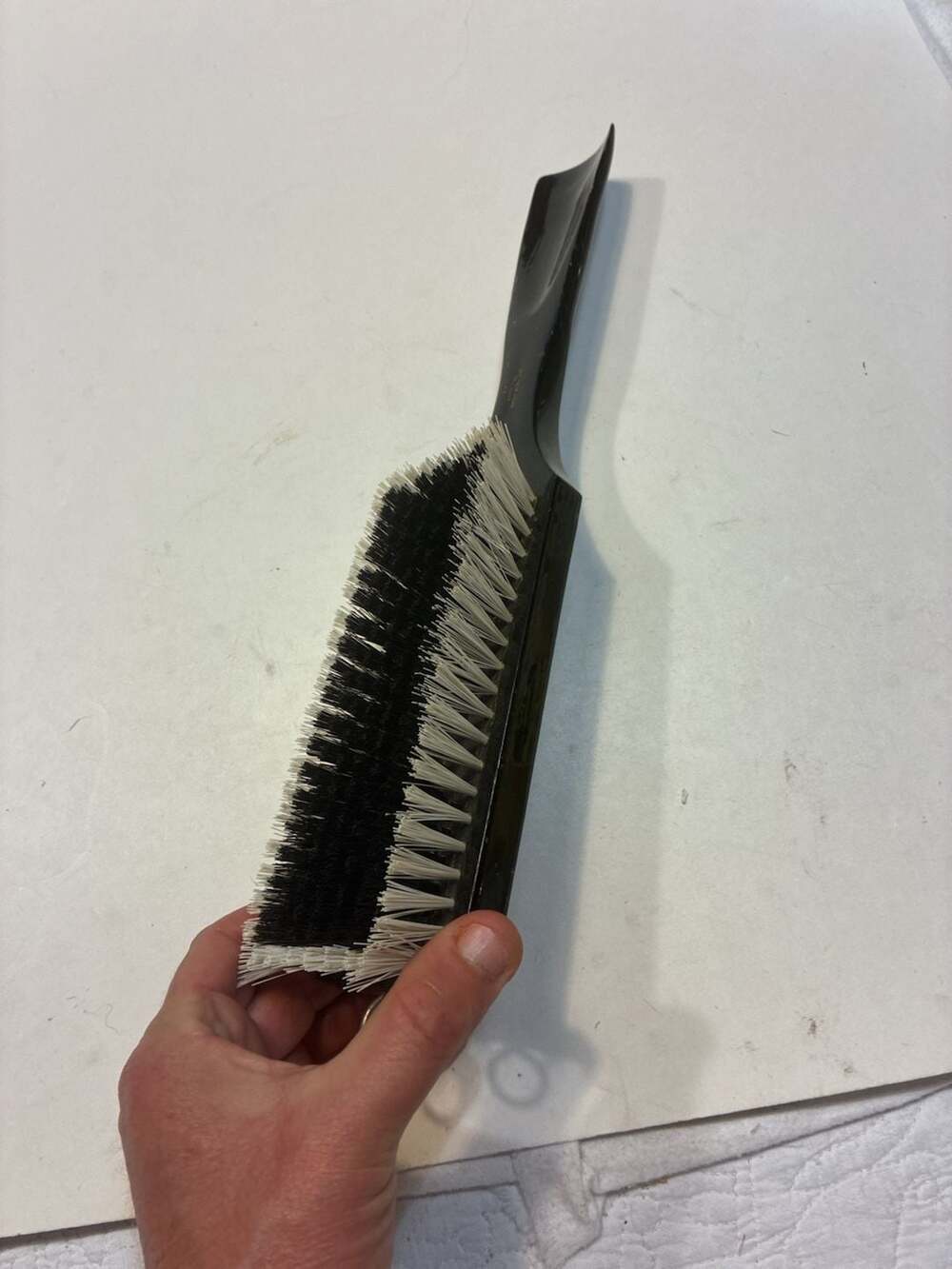 This is a vintage Swank clothing brush with a wooden shoe horn handle, made in W